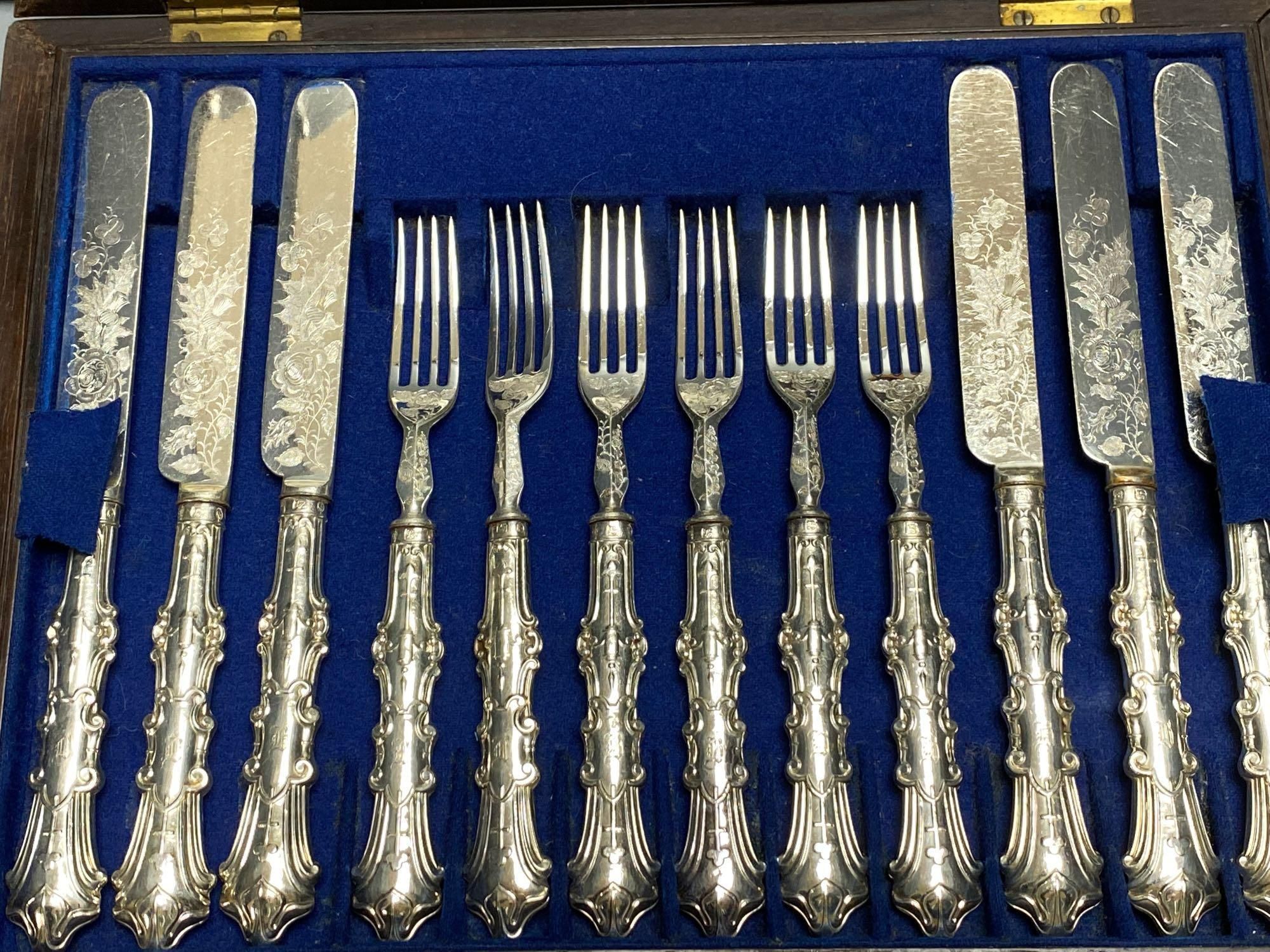 A Victorian rosewood cased set of eighteen plated dessert knives and forks, and two other cased sets of plated cutlery